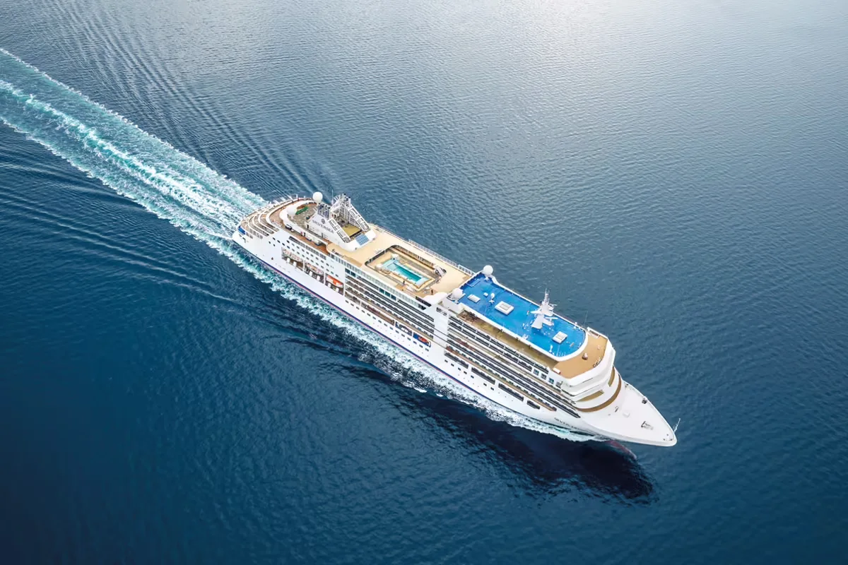 Silversea small luxury ship viewed from directly above, cutting a white wake through deep blue ocean